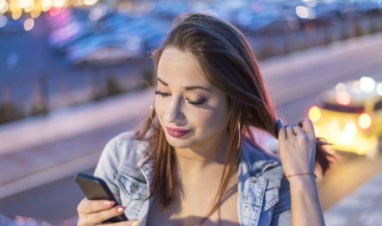 woman on smartphone in urban setting
